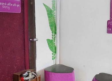 Purple waiting area with leaf decor at Yogi Spa, Bali, Bali, ID, offering a welcoming ambience.