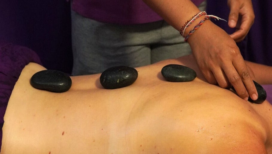 Relaxing stone massage at Yogi Spa, Bali, Bali, ID, promoting wellness and rejuvenation.