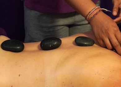Relaxing stone massage at Yogi Spa, Bali, Bali, ID, promoting wellness and rejuvenation.