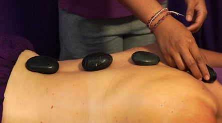Relaxing stone massage at Yogi Spa, Bali, Bali, ID, promoting wellness and rejuvenation.