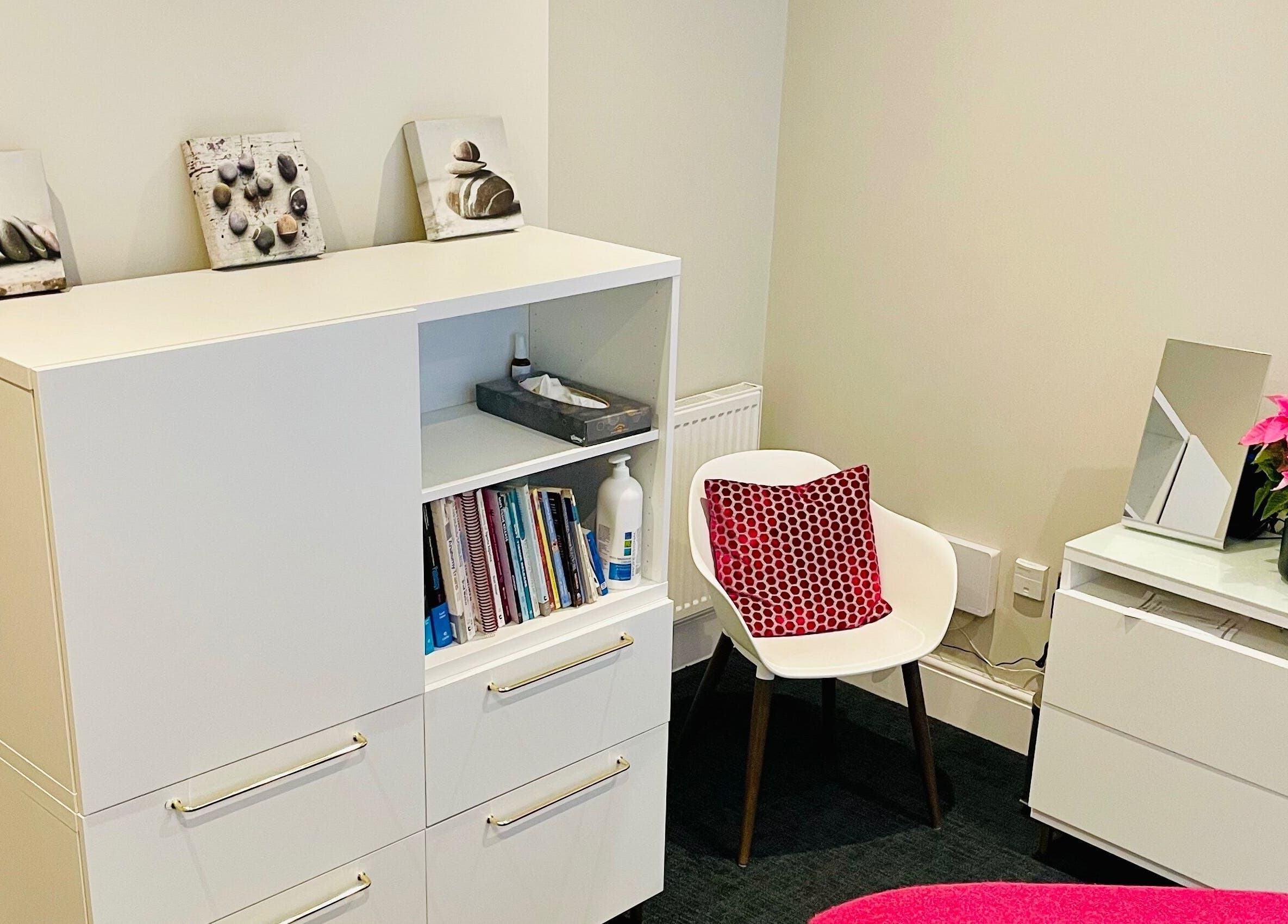 Relaxing therapy room at Recharge with Katrina -Henley on Thames, featuring bright decor and cozy seating.
