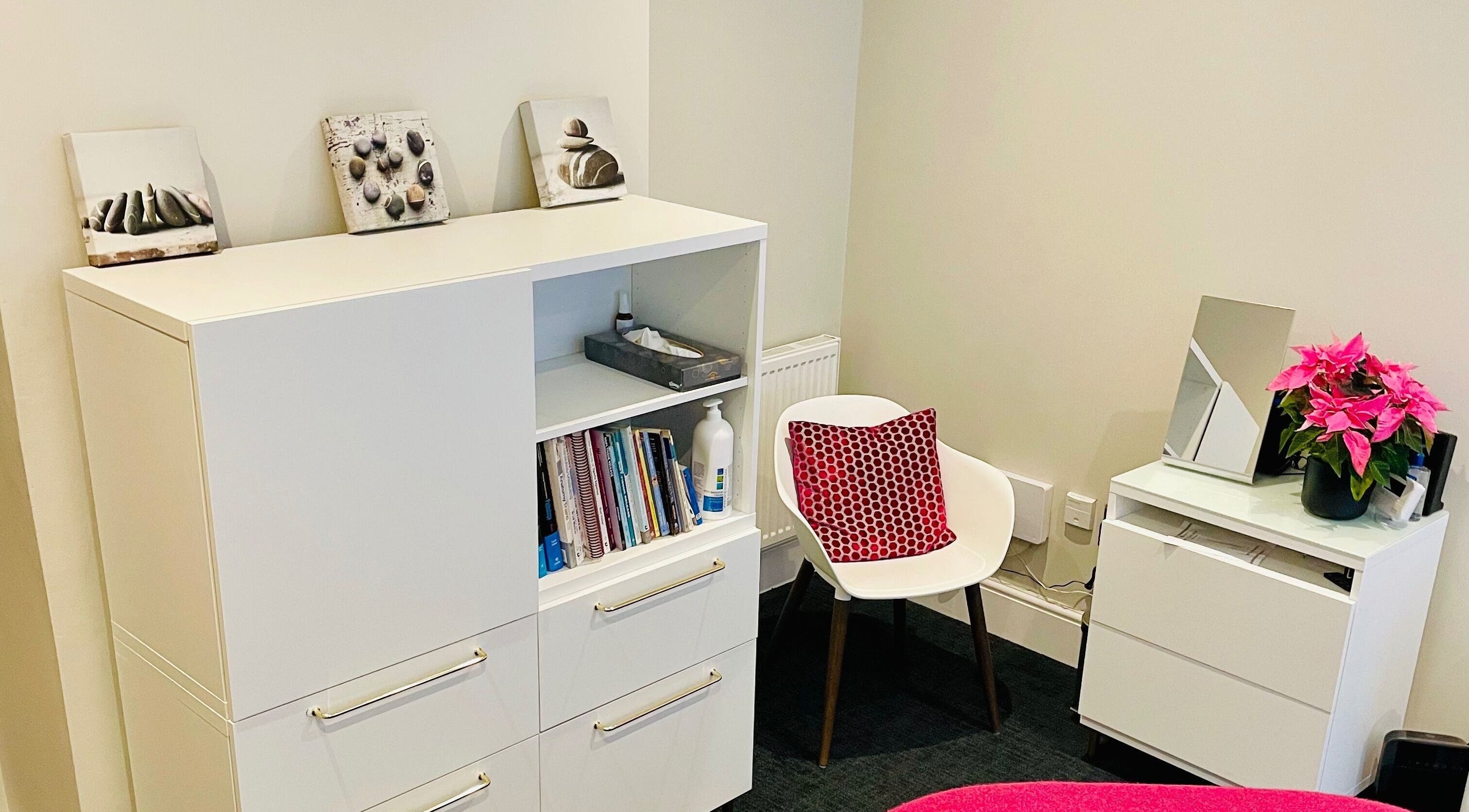 Relaxing therapy room at Recharge with Katrina -Henley on Thames, featuring bright decor and cozy seating.