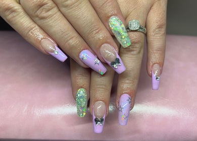 Elegant lavender nail art with glitter and bows at Tegan Maree Beauty, Orange, New South Wales, AU.