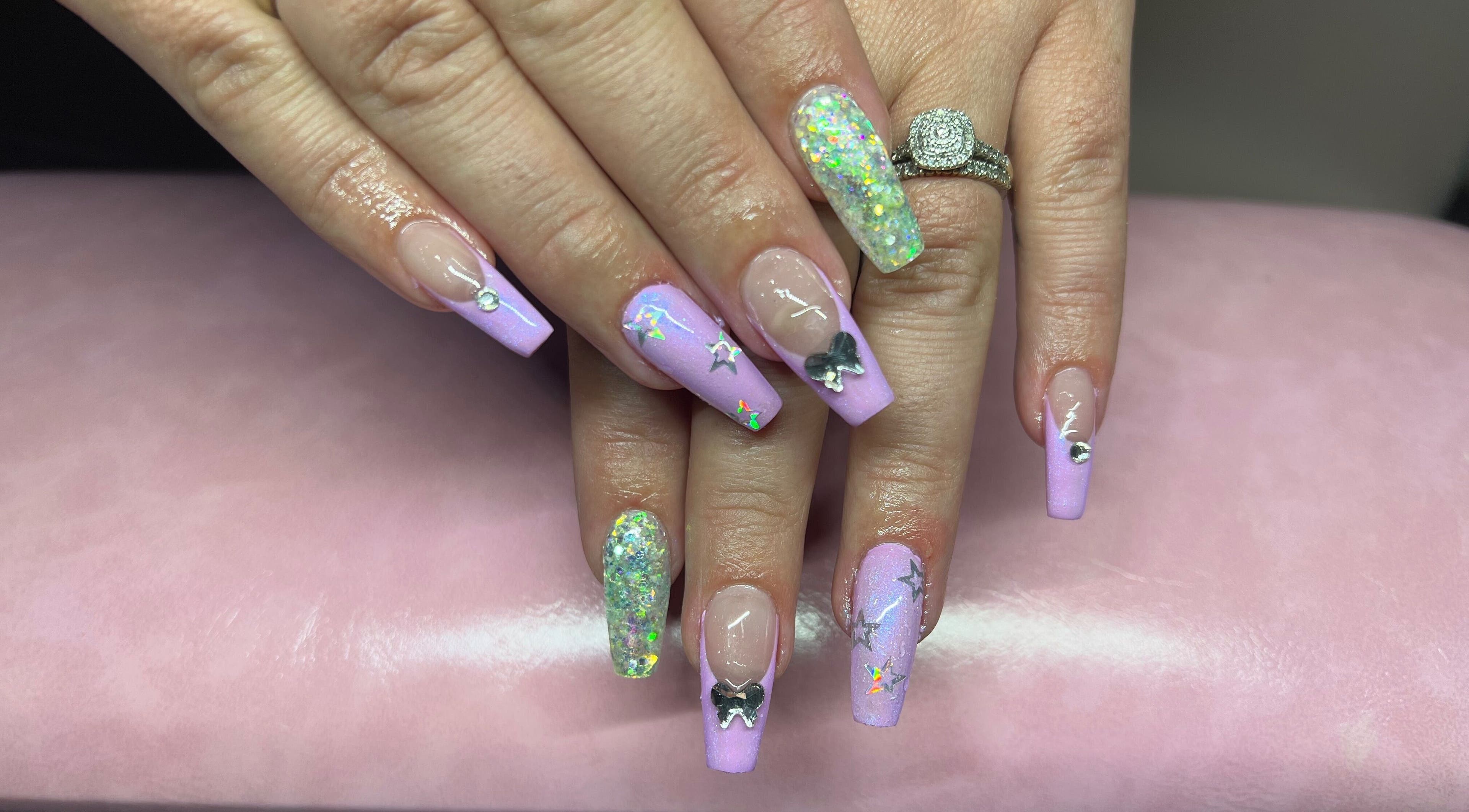 Stylish nail art with purple glitter and designs at Tegan Maree Beauty, Orange, New South Wales, AU.