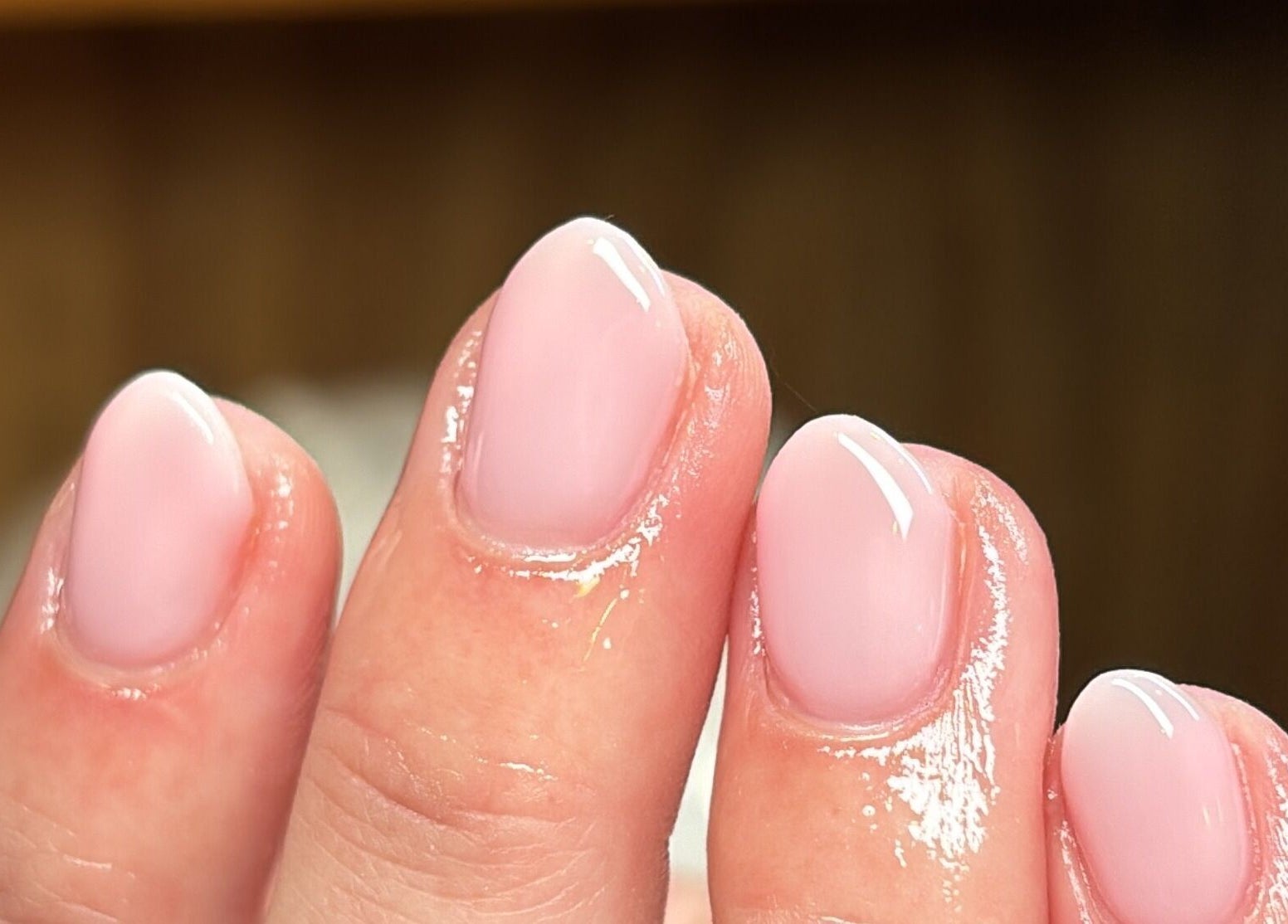Close-up of glossy pink manicure at Slayed by NHI, Glen Mills, Pennsylvania, US.
