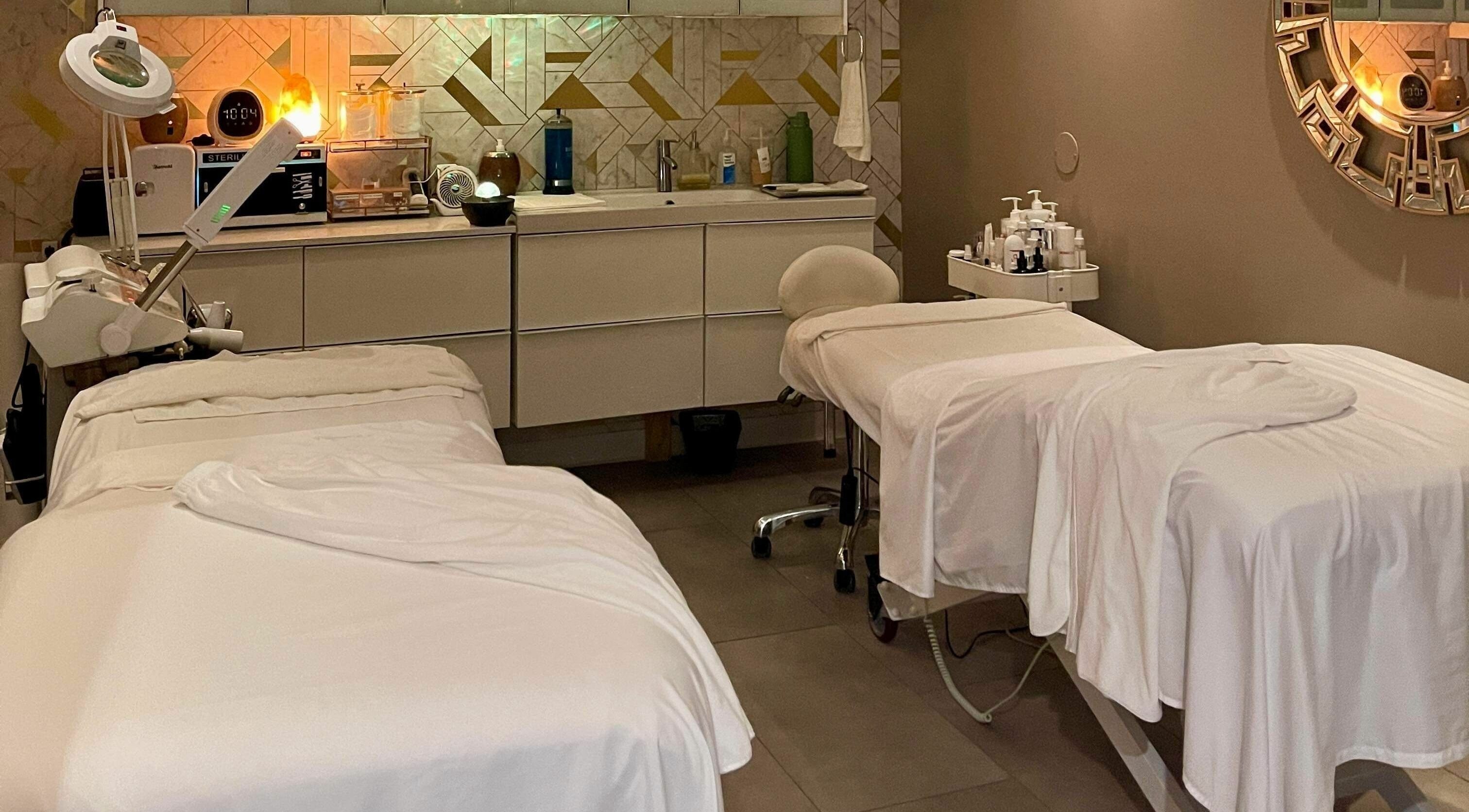 Luxurious spa room at Gangnam Medical Spa in Manchester, Missouri, US, featuring two massage beds and ambient lighting.