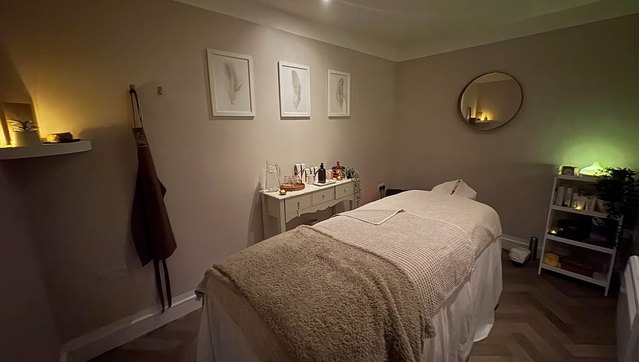 Relaxing treatment room at The Holt Wellness, Exeter, England, GB, with soft lighting and cozy decor.