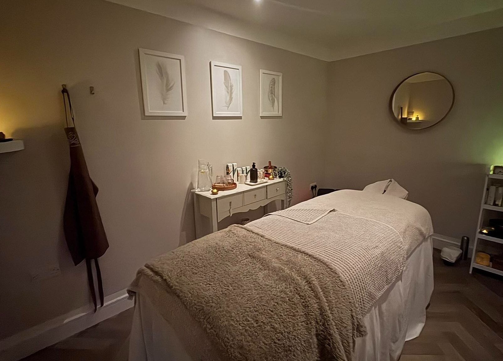 Relaxing treatment room at The Holt Wellness, Exeter, England, GB, with soft lighting and cozy decor.