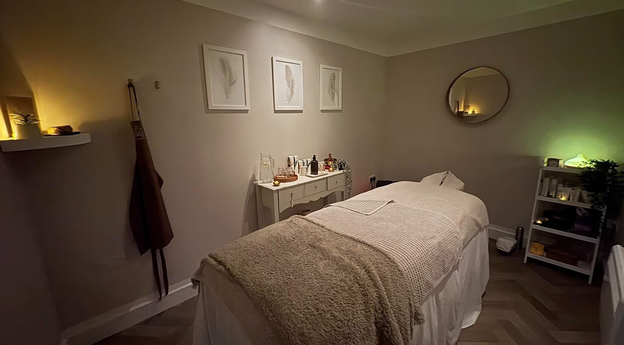 Relaxing treatment room at The Holt Wellness, Exeter, England, GB, with soft lighting and cozy decor.