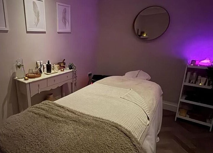 Luxurious massage room at The Holt Wellness, Exeter, England, GB. Ambient lighting and plush decor create a serene escape.