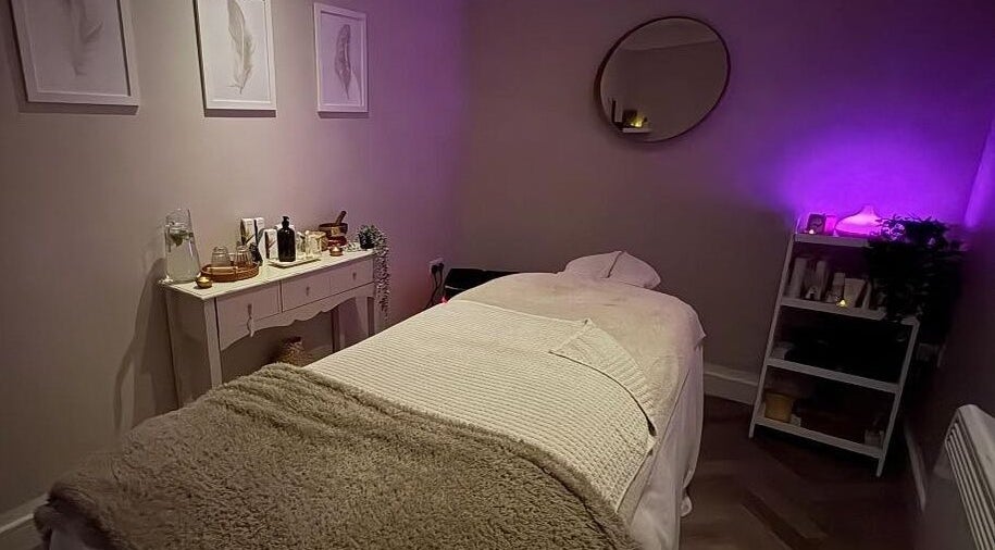 Luxurious massage room at The Holt Wellness, Exeter, England, GB. Ambient lighting and plush decor create a serene escape.