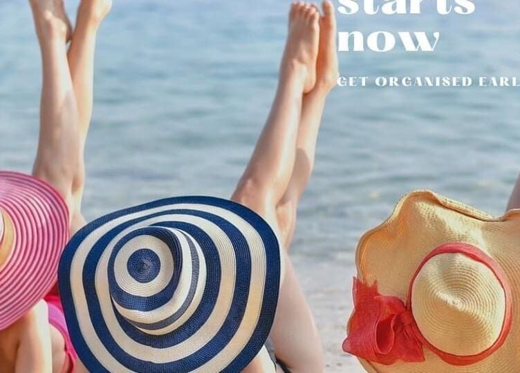 Three women in hats relax on a beach at Beauty by Caroline, Silsoe, England, GB.