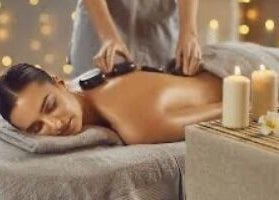 Relaxing hot stone massage at Beauty by Caroline in Silsoe, England, GB with soothing candles.