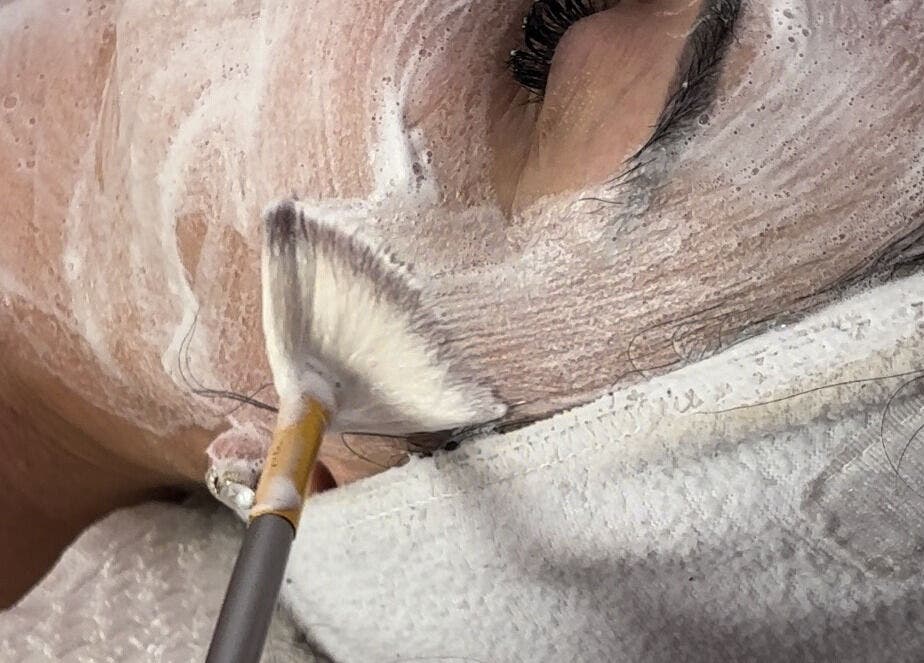 Facial treatment at Moonskyn, Montréal, Québec, CA, featuring a soothing foam mask applied with precision.