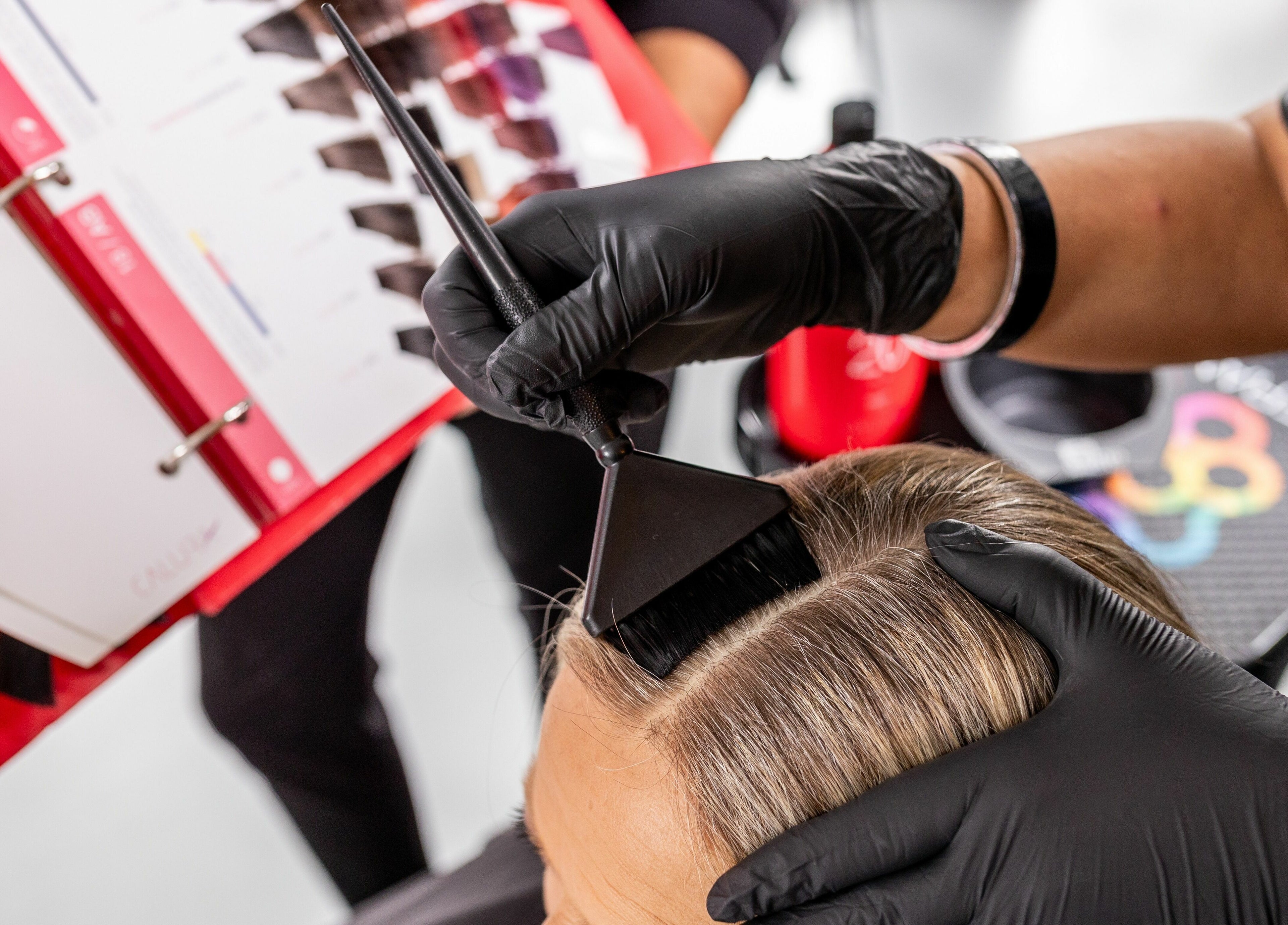 Hair coloring in progress at Lolo's Salon in Laval, Québec, CA with expert stylist applying dye.