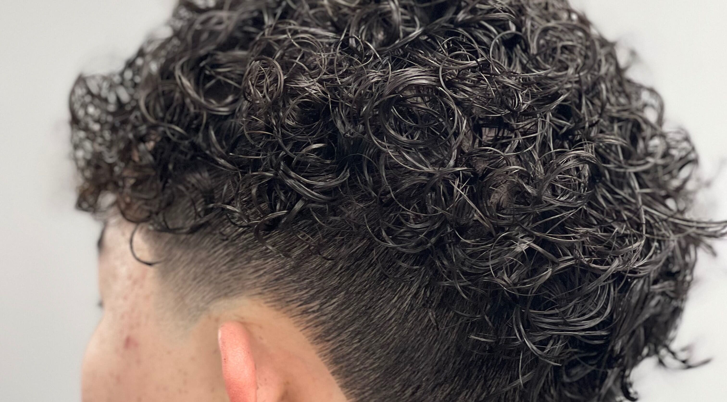 Close-up of trendy curly fade hairstyle at Passion Salon and Spa (Victoria Ave East), Regina, Saskatchewan, CA.