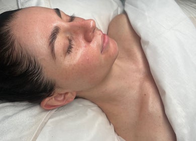 A serene woman enjoying a facial treatment at That Glow in Melbourne, Victoria, AU.