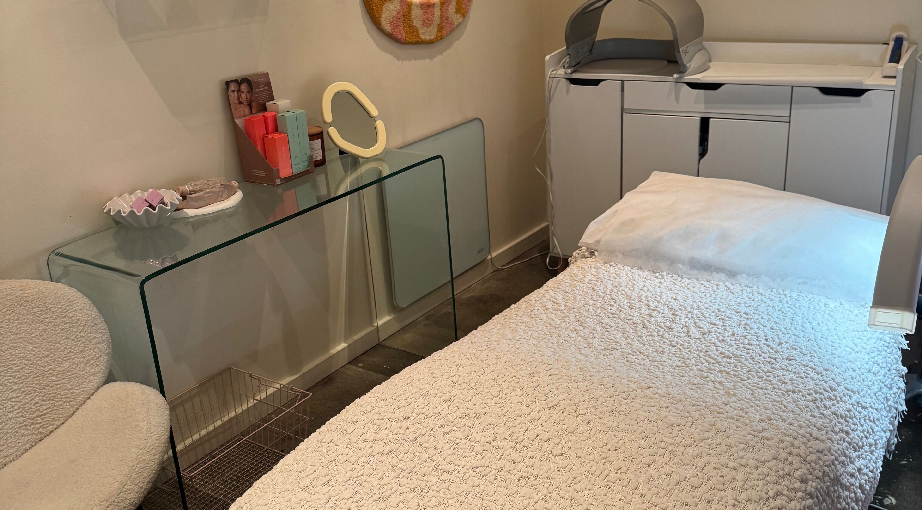 Serene treatment room at That Glow, Melbourne, Victoria, AU, featuring a plush white bed and modern decor.