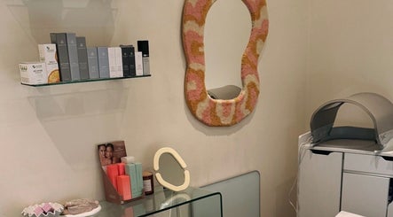 Stylish skincare room at That Glow, Melbourne, Victoria, AU featuring products and a decorative mirror.