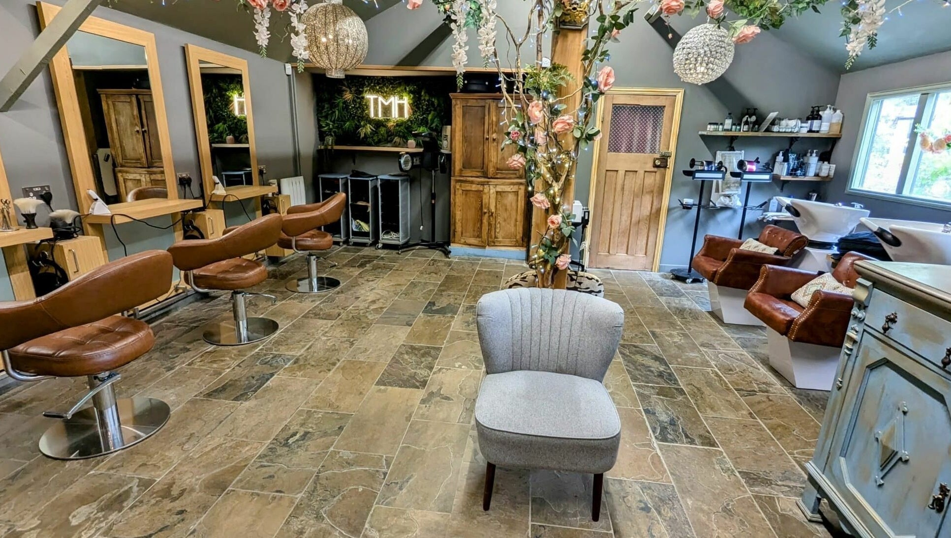 Chic interior of The Mane House salon in Biddenden, England, featuring stylish seating and modern decor.
