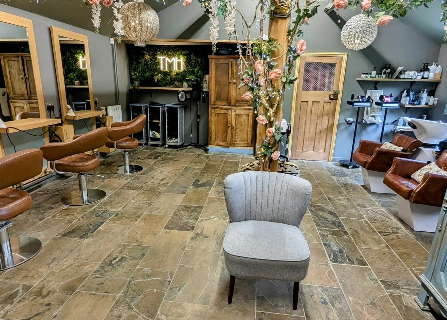 Chic interior of The Mane House salon in Biddenden, England, featuring stylish seating and modern decor.