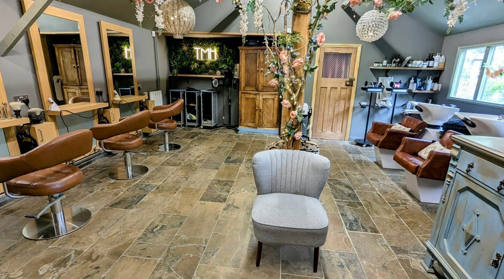 Chic interior of The Mane House salon in Biddenden, England, featuring stylish seating and modern decor.