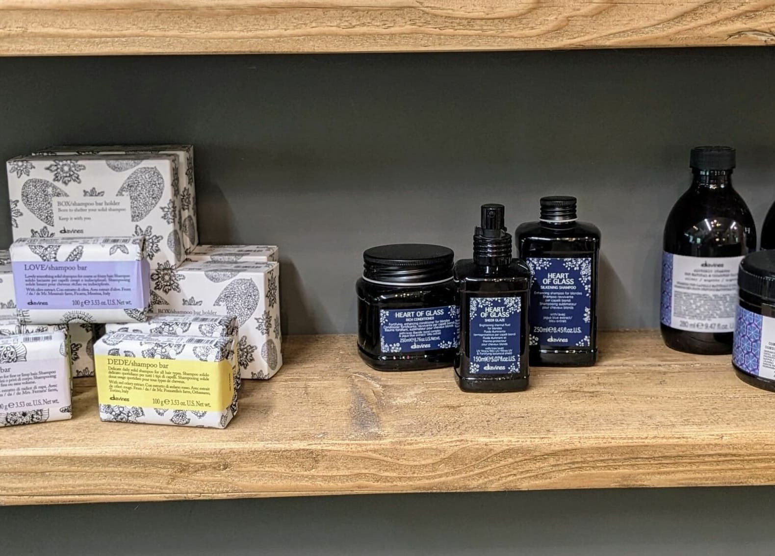 Luxury shampoo and soap bars on a wooden shelf at The Mane House, Biddenden, England, GB.