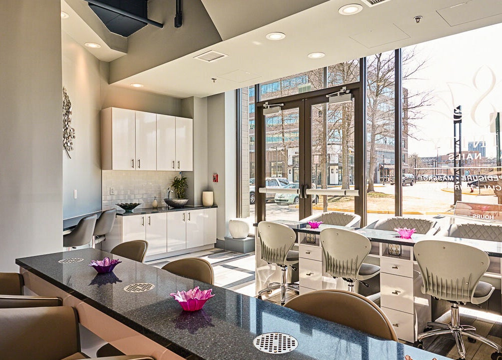 Interior of Infinity Spa Nails in Reston, Virginia, US, showcasing elegant nail stations and stylish decor.