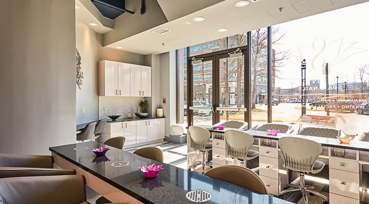 Interior of Infinity Spa Nails in Reston, Virginia, US, showcasing elegant nail stations and stylish decor.