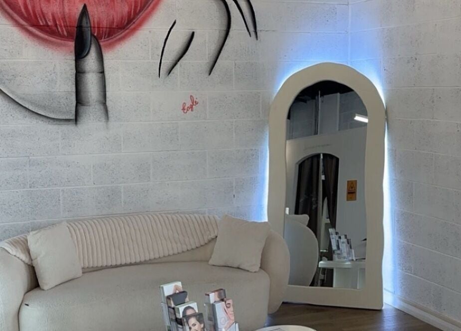 Stylish lounge area with mirror at Epidermis (Located in The Aesthetique Co), Panania, New South Wales, AU.