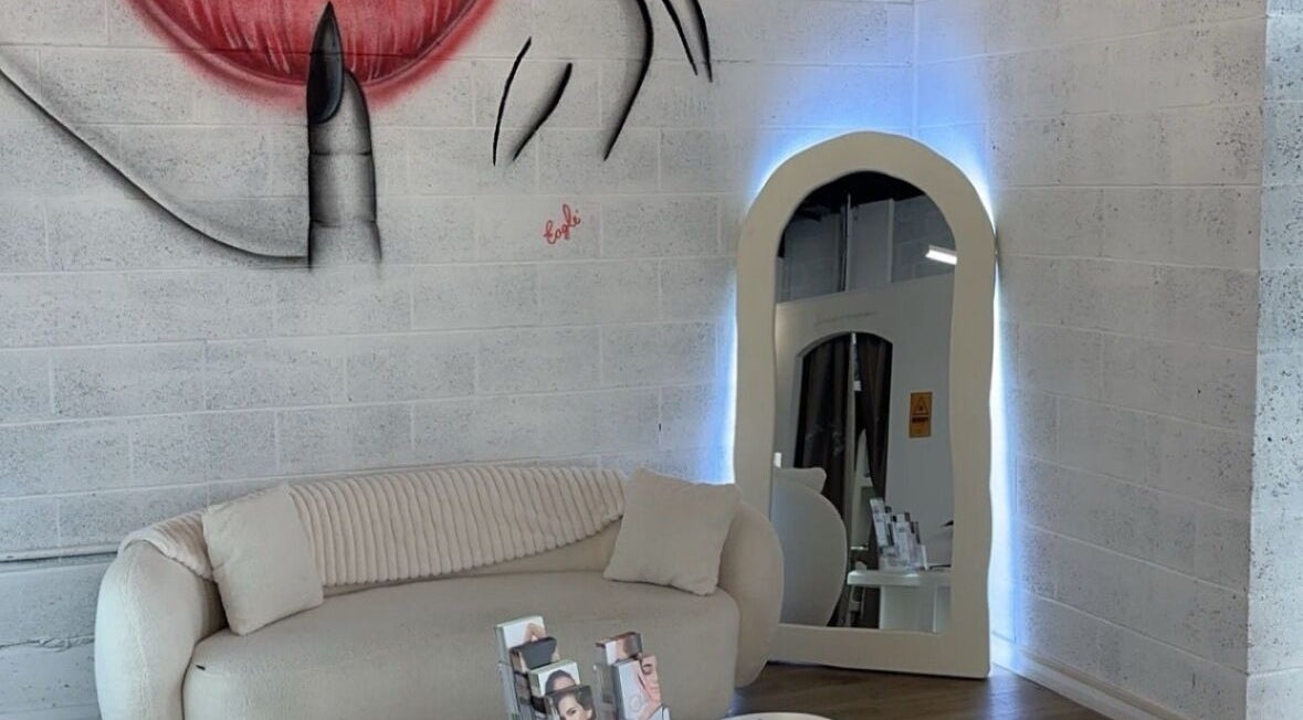 Stylish lounge area with mirror at Epidermis (Located in The Aesthetique Co), Panania, New South Wales, AU.