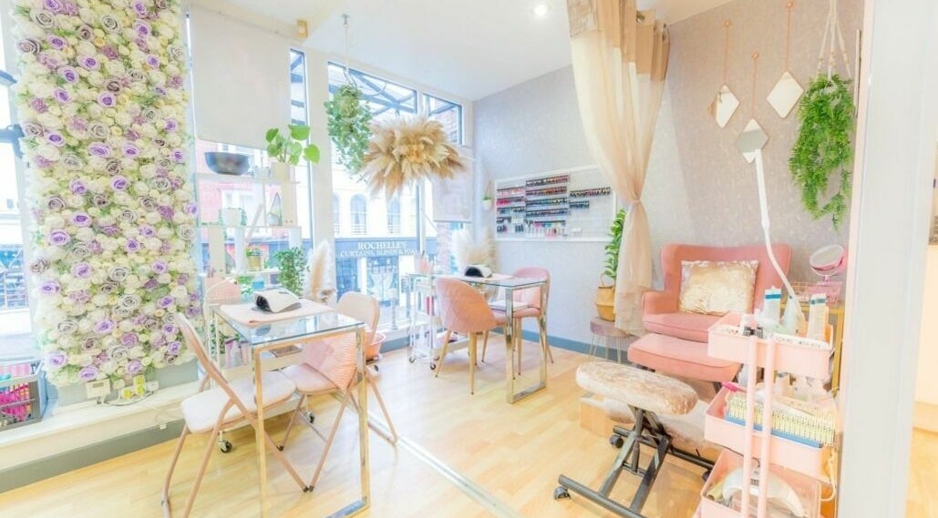 Chic nail studio interior at Viva Hair, Exeter, England, GB, featuring floral decor and modern furniture.