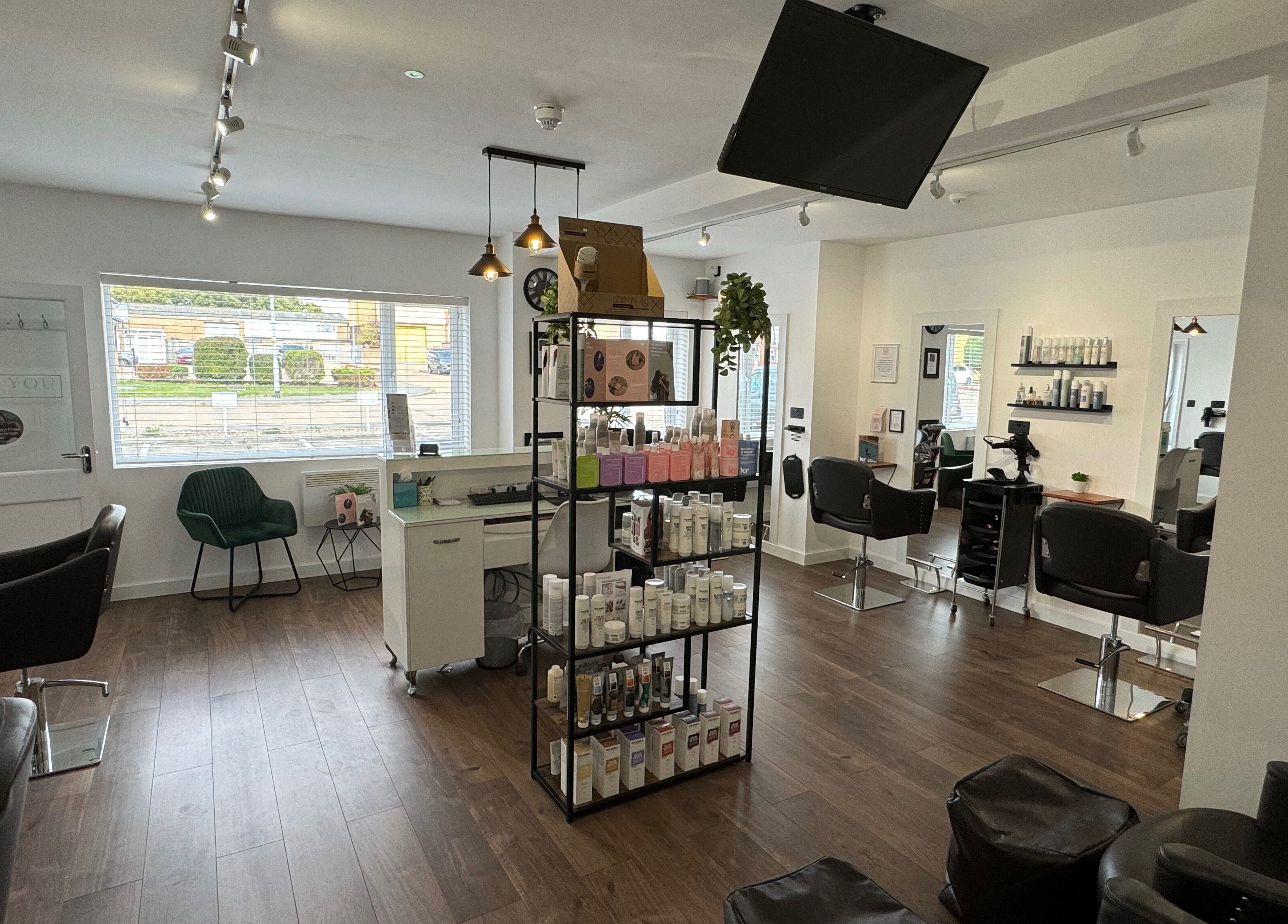 Interior view of New You Hair Salon, Clacton-on-Sea, GB showcasing modern chairs and product display.