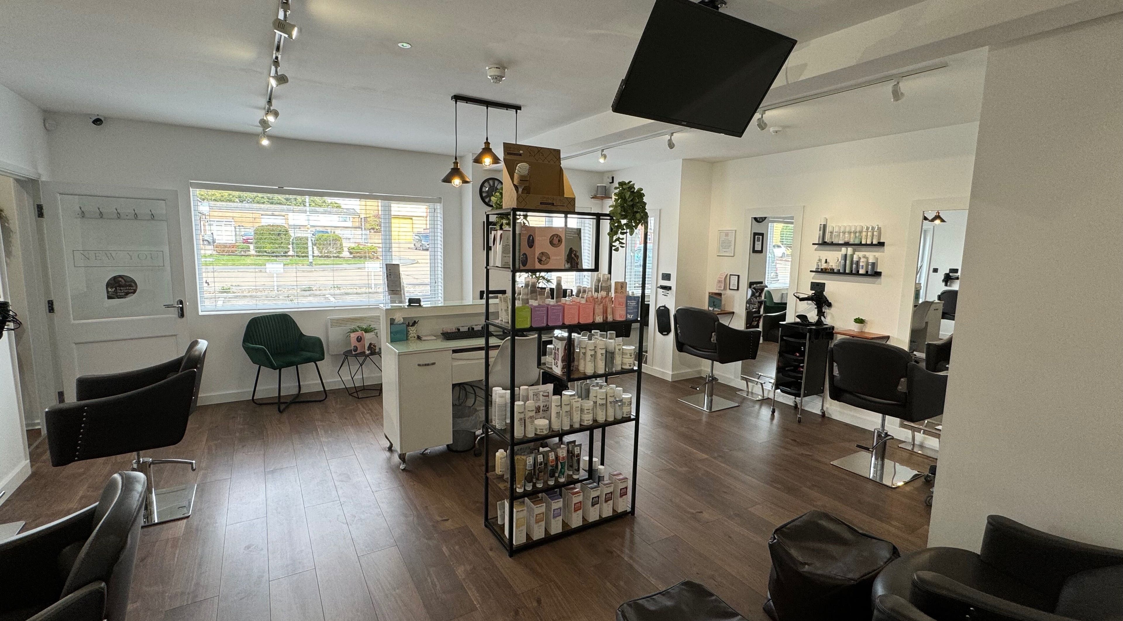 Interior view of New You Hair Salon, Clacton-on-Sea, GB showcasing modern chairs and product display.