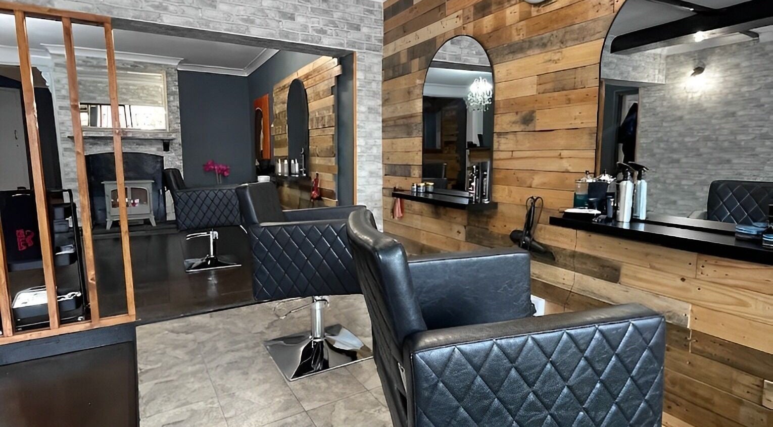 Modern salon interior at David John Hair Company, Royal Wootton Bassett, England, with elegant styling chairs.