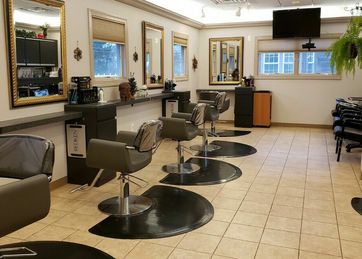 Modern salon interior at Raymond Salon N Spa, Franklin Township, New Jersey, US featuring sleek styling stations.