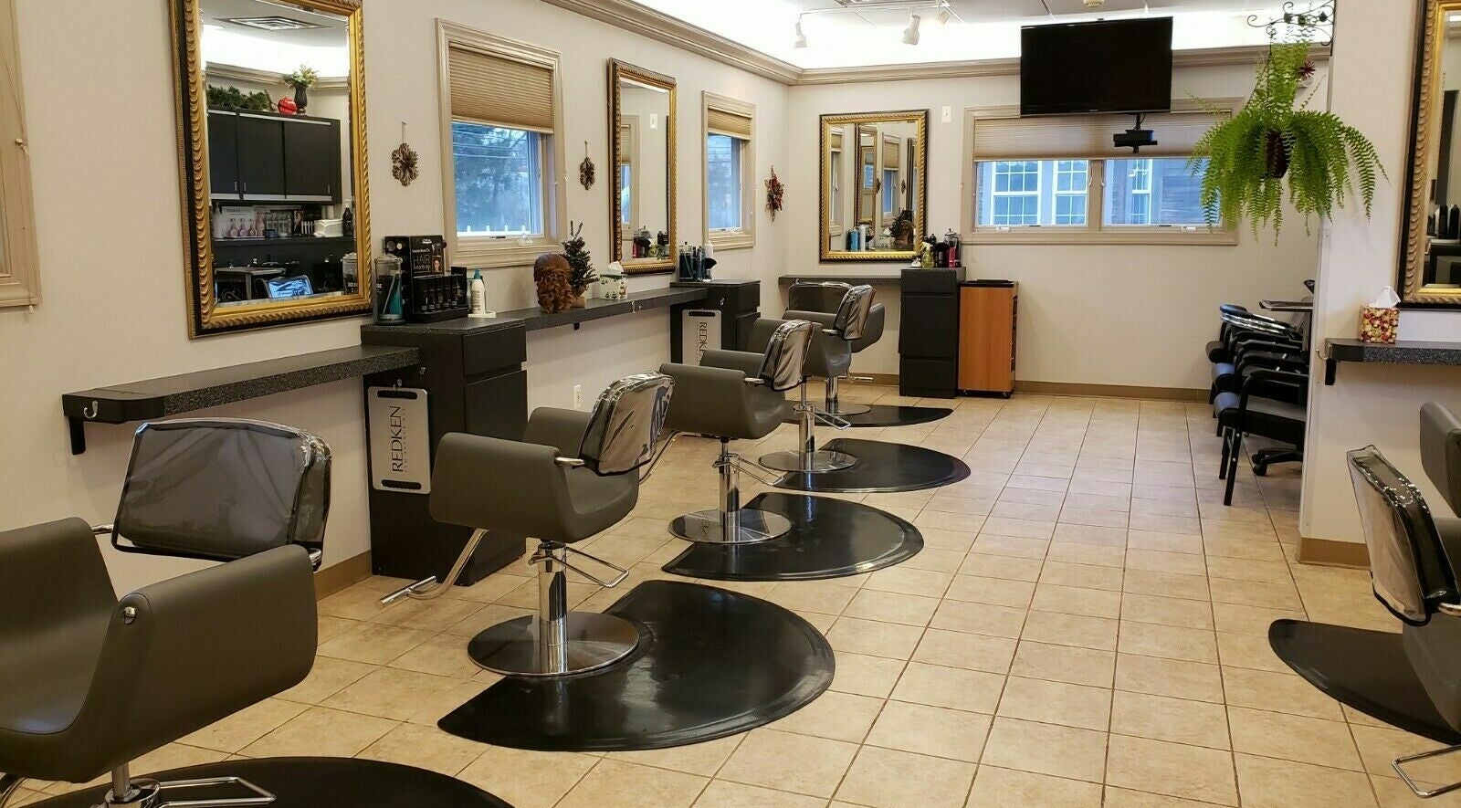 Modern salon interior at Raymond Salon N Spa, Franklin Township, New Jersey, US featuring sleek styling stations.
