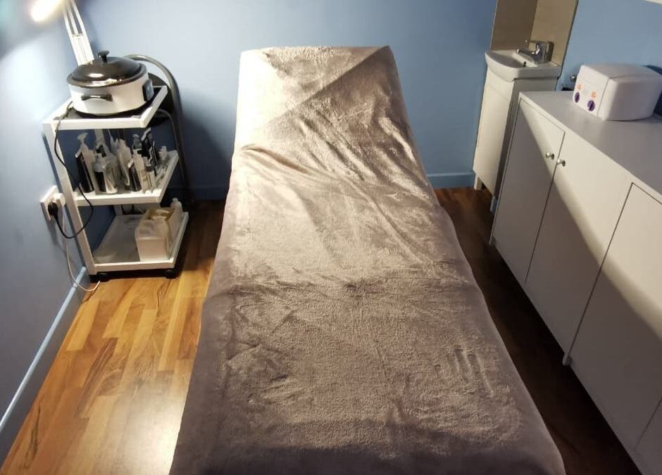 Tranquil treatment room at Ebody, Gorey, County Wexford, IE, featuring a comfortable treatment bed.
