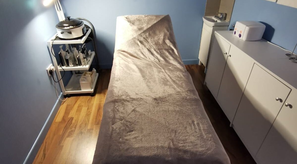 Tranquil treatment room at Ebody, Gorey, County Wexford, IE, featuring a comfortable treatment bed.