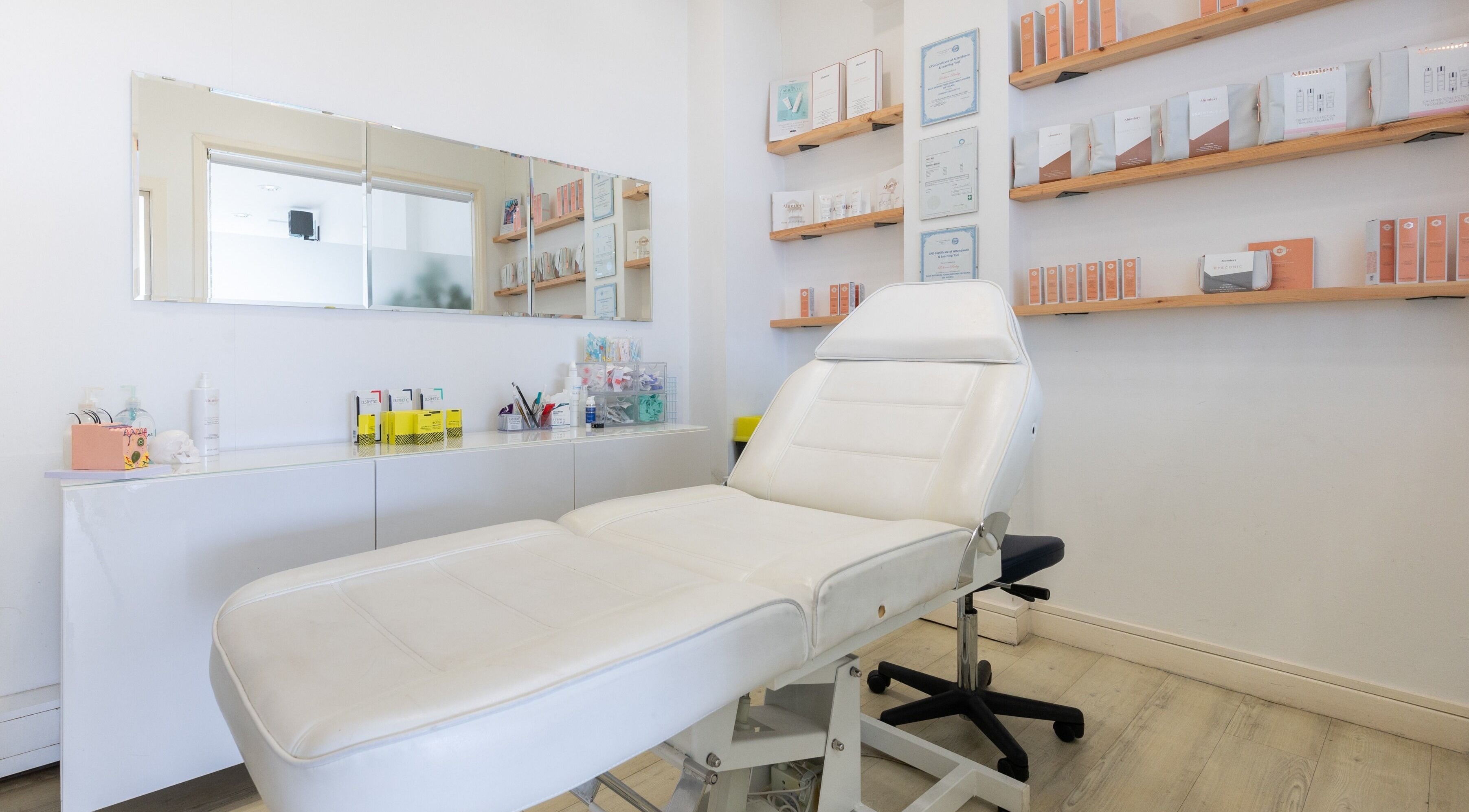 Elegant treatment room at Preen, Stockport, England, GB, featuring a plush white massage table.