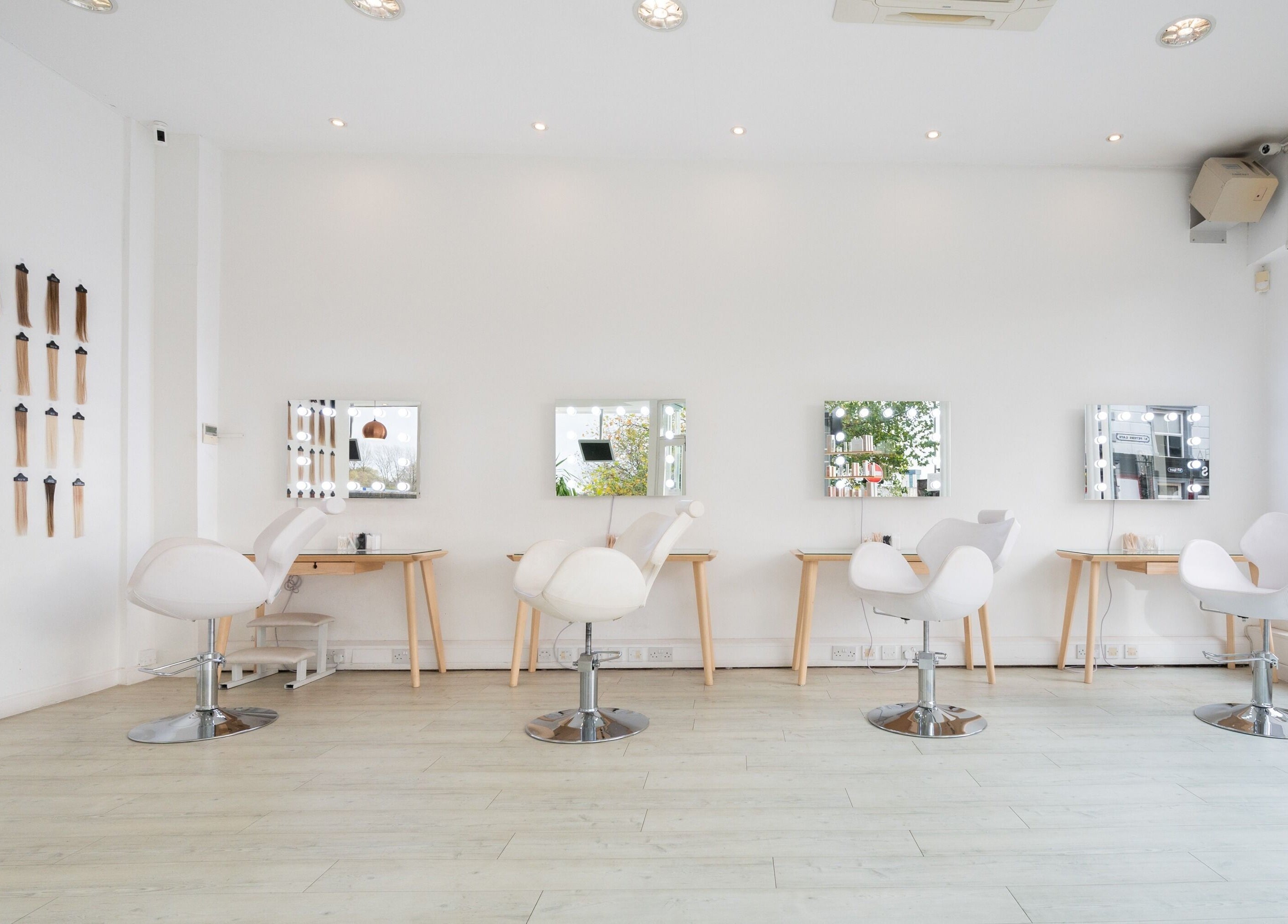 Modern salon chairs and mirrors at Preen, Stockport, England, GB, showcasing a stylish beauty space.