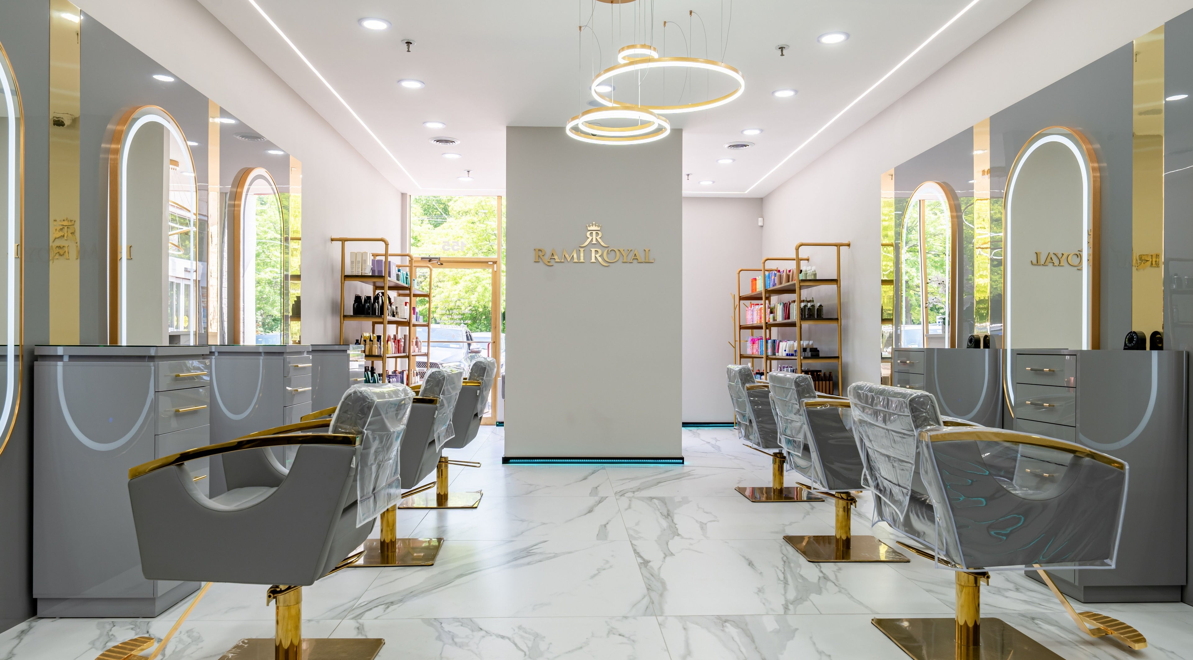 Elegant interior of Rami Royal Hair Salon in Oyster Bay, New York, US with modern decor and styling chairs.