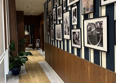 Stylish hallway at Barberia Italiana Grooming Lounge Ltd., Dubai, Dubai, AE, featuring framed art and elegant decor.
