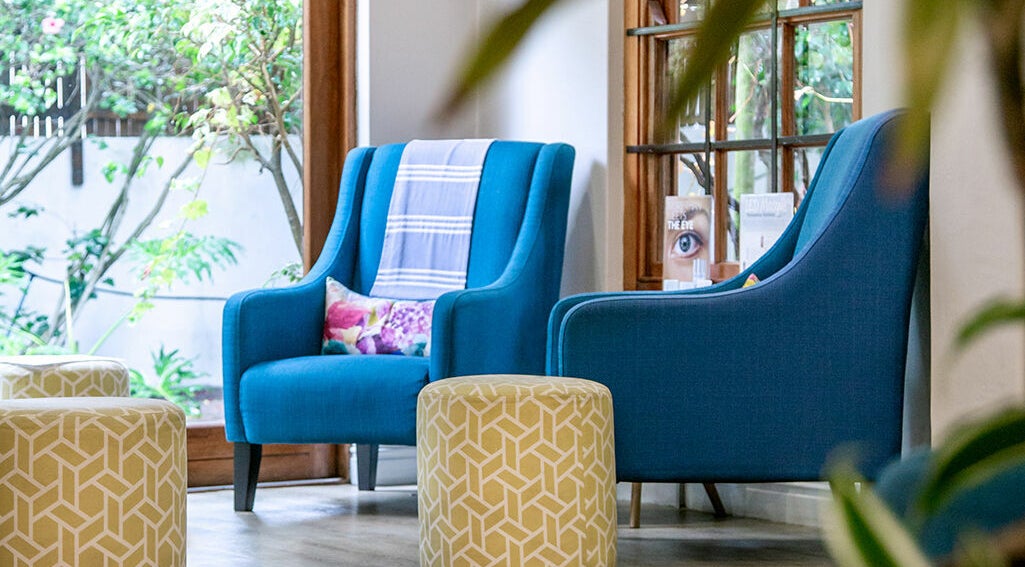 Relaxing blue chairs and green stools at Gingerlily Spa, Cape Town, Western Cape, ZA.