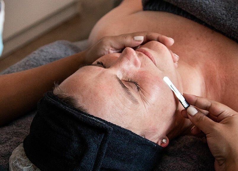 Client enjoying dermaplaning at Gingerlily Spa, Cape Town, Western Cape, ZA, enhancing skin glow and texture.