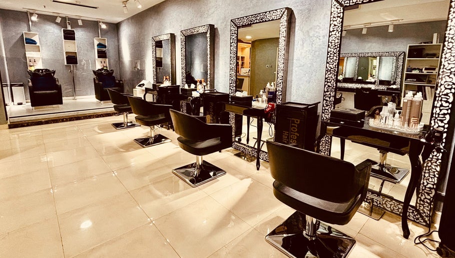 Chic interior of Glitz Beauty Center in Dubai, AE showcasing luxurious salon chairs and mirrors.