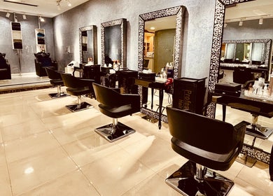 Chic interior of Glitz Beauty Center in Dubai, AE showcasing luxurious salon chairs and mirrors.