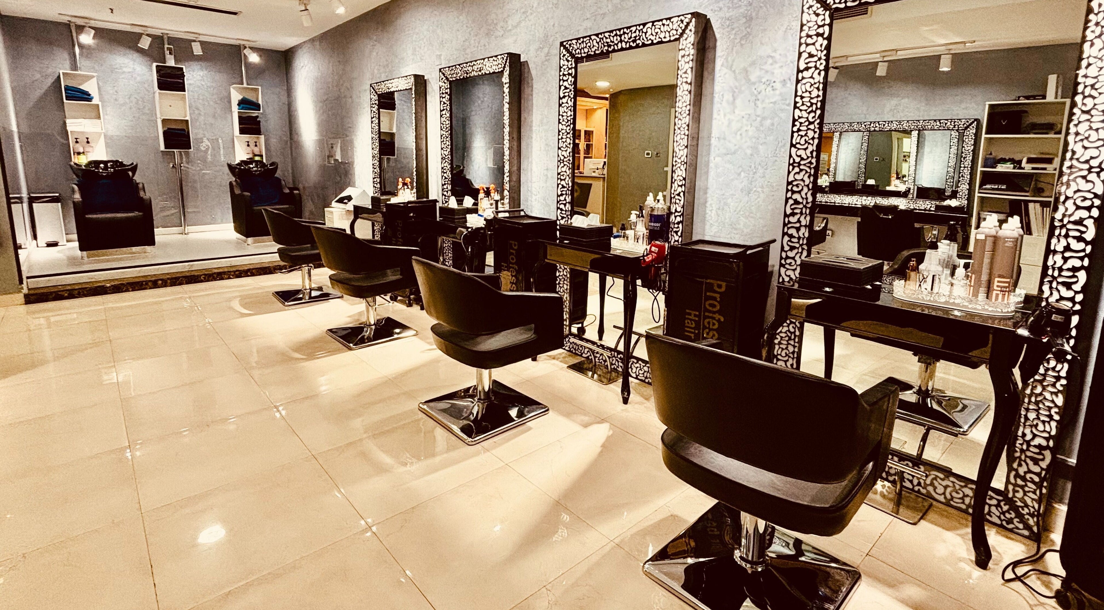Chic interior of Glitz Beauty Center in Dubai, AE showcasing luxurious salon chairs and mirrors.