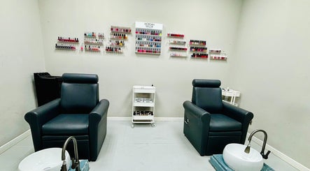 Luxurious manicure chairs at Glitz Beauty Center, Dubai, AE, showcasing nail polish collection.