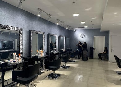 Chic salon interior of Glitz Beauty Center in Dubai, AE, featuring modern styling stations and elegant decor.